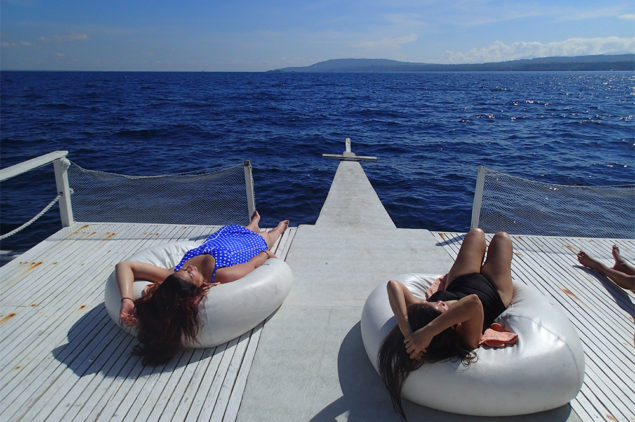 Happy guests sun bathing at a boat in Davao